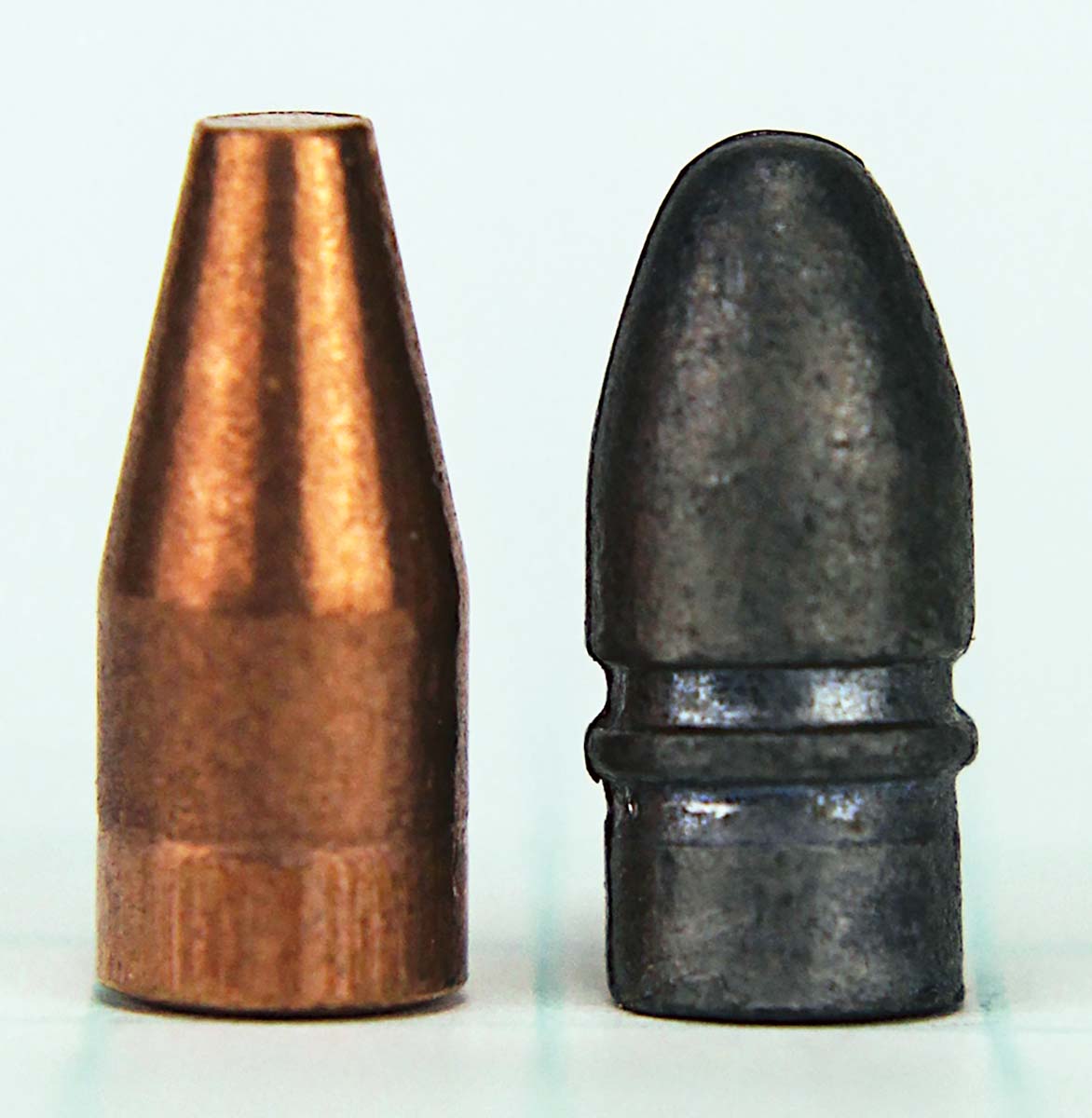 The 21 Sharp’s bullet (left) dispenses with the 22 Long Rifle bullet’s round nose and heel base (right). Bullet diameter is reduced from .2255 inch to .2105 inch.